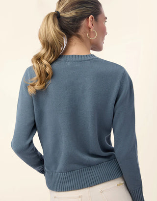 back of Woman wearing a blue sweater