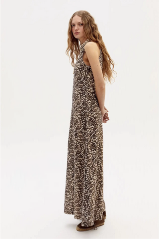 Woman wearing a long floral dress on a white background